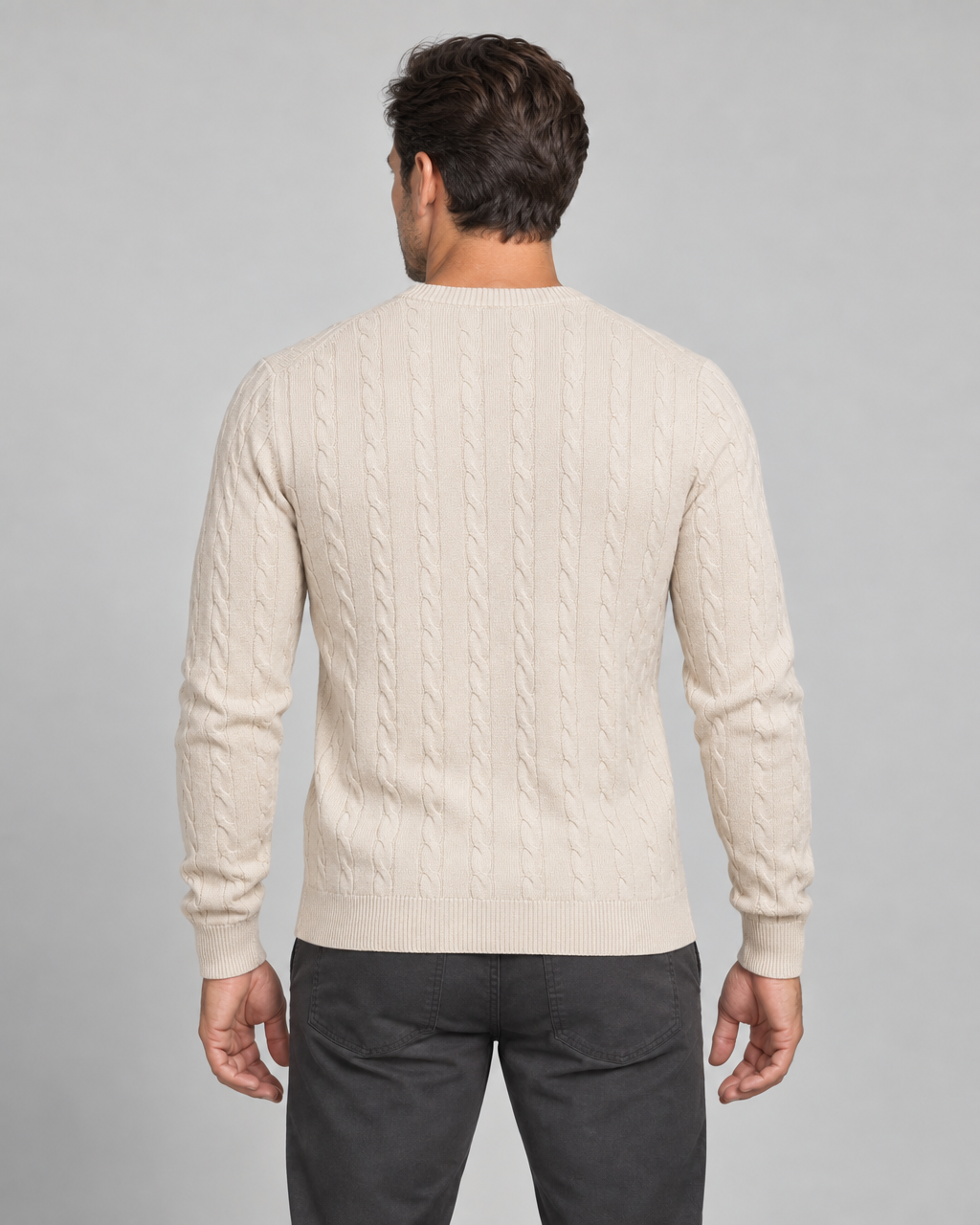 Cream cable-knit jumper shown from the rear, cropped from head to upper thighs