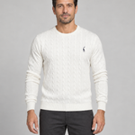 Front cropped view of a man wearing a white cable-knit crew-neck jumper with a small dark chest motif.