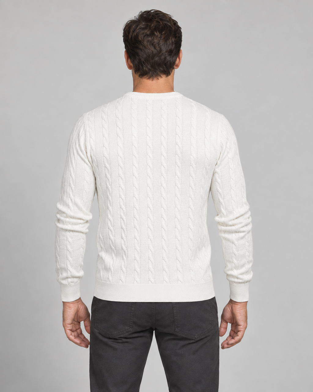 Back crop of a man wearing a white cable-knit crew-neck jumper with ribbed cuffs and hem
