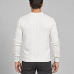 Back crop of a man wearing a white cable-knit crew-neck jumper with ribbed cuffs and hem