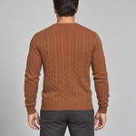 Man shown from behind wearing a brown cable-knit crew-neck jumper, cropped at the thighs.
