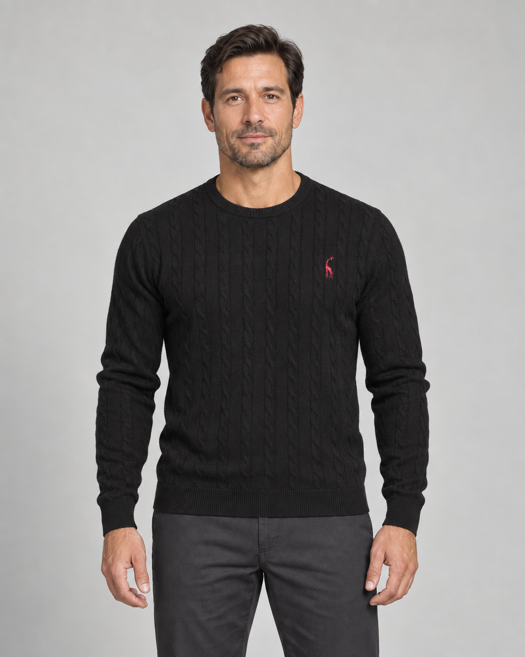 Front cropped view of a black cable-knit crew-neck jumper with a small red giraffe motif on the chest.