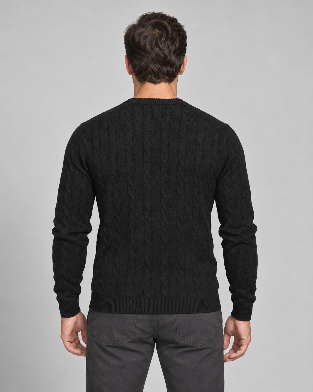 Cropped rear view of a model wearing a black cable-knit crew-neck jumper