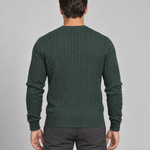 Back view of a man wearing a dark green cable-knit crew-neck jumper with long sleeves and ribbed trims.