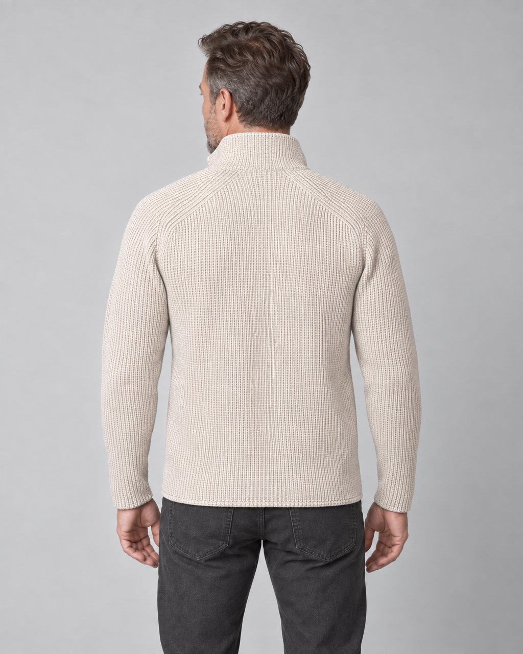 Back view of a man wearing a beige ribbed roll-neck jumper with long sleeves