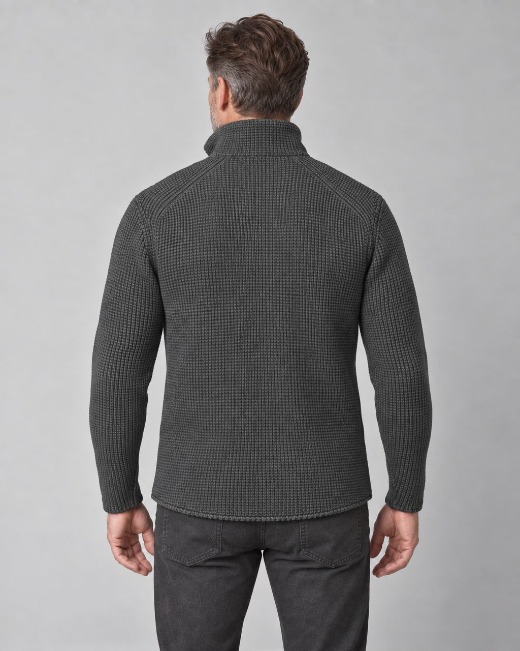 Cropped back view of a man wearing a dark grey textured jacket with a high collar and long sleeves