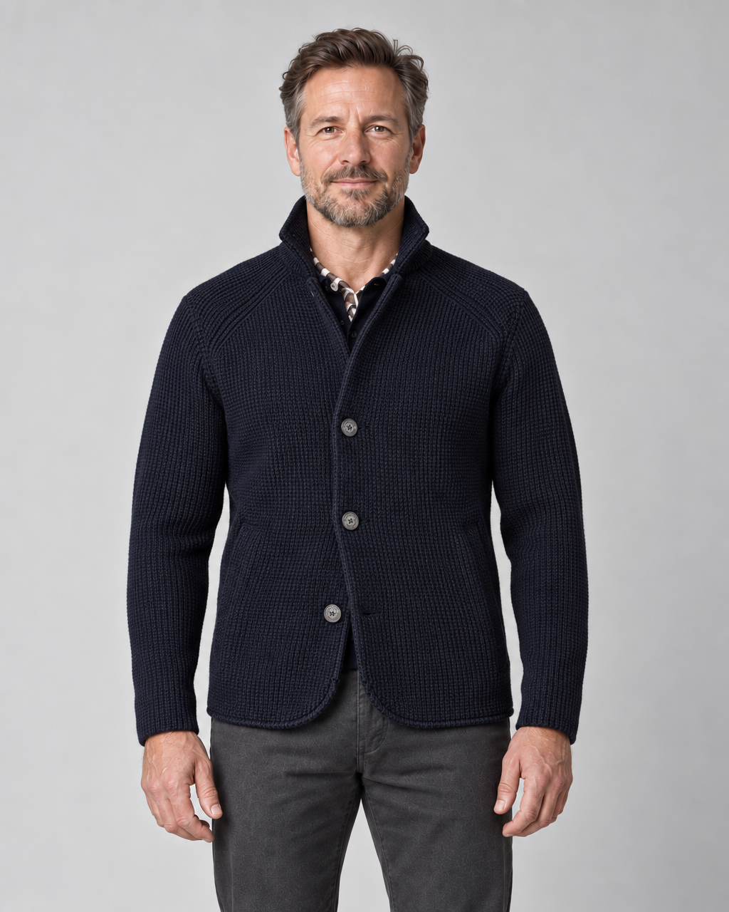 Front cropped view of a man wearing a marine blue textured jacket with a raised collar and three-button fastening