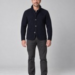 Full-length front view of a man wearing a marine blue textured button-up jacket with a raised collar