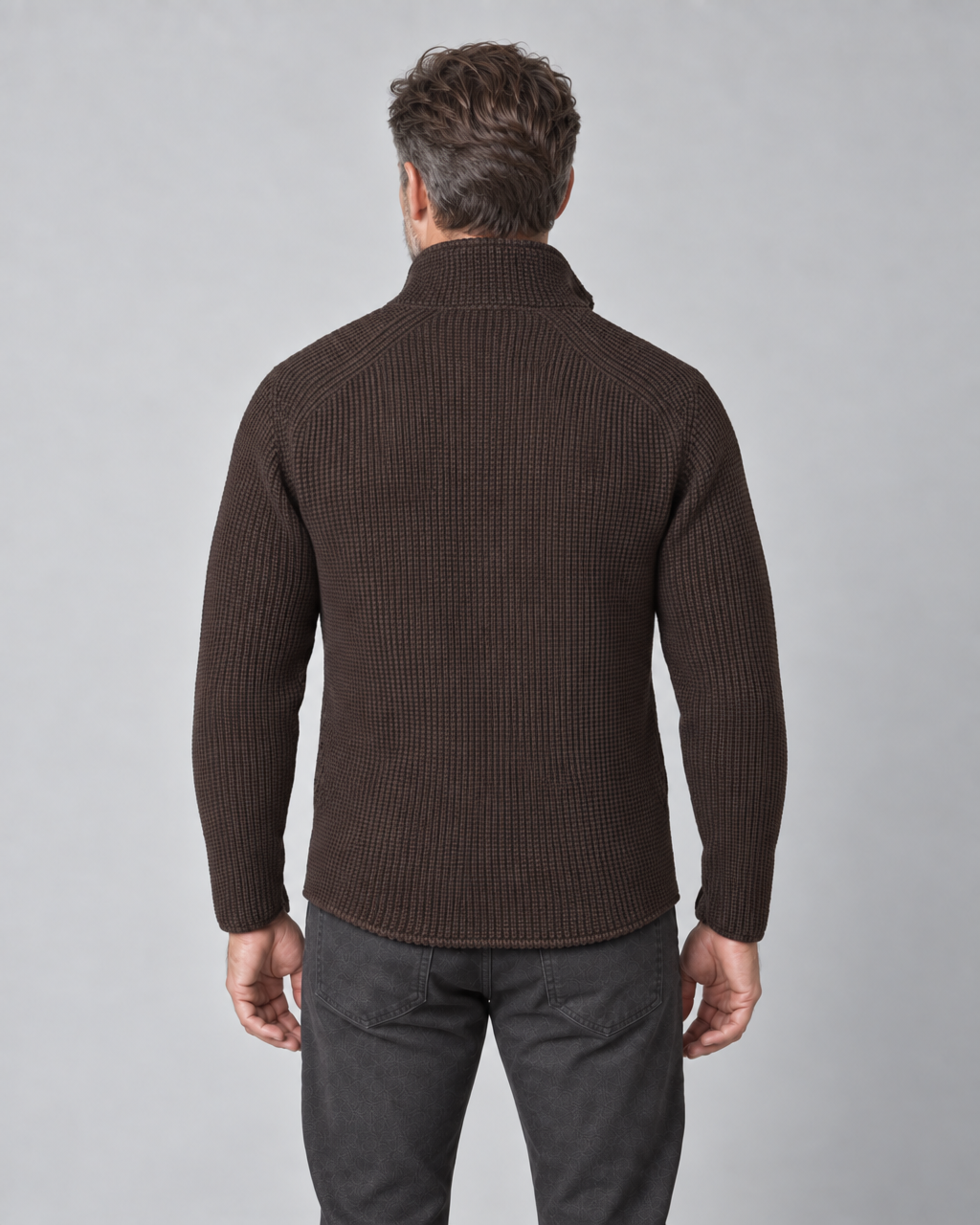 Cropped back view of a man wearing a dark brown ribbed jacket with a high collar