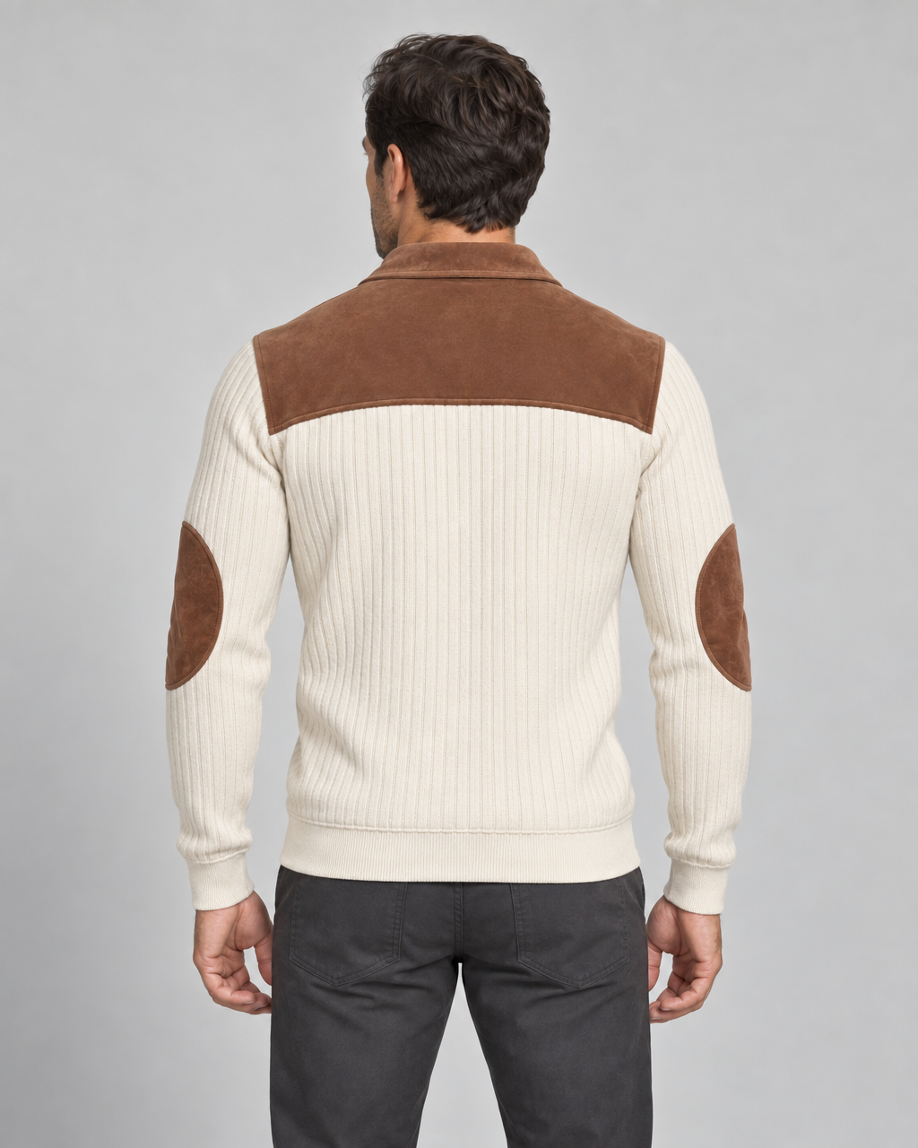 Back view of a beige ribbed sweater with a brown shoulder yoke, collar and oval elbow patches.