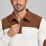 Close-up front view of a white ribbed sweater with a brown yoke, pointed collar and quarter-zip fastening.