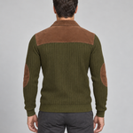 Back view of a man in an olive-green ribbed jumper with a brown shoulder panel and elbow patches.