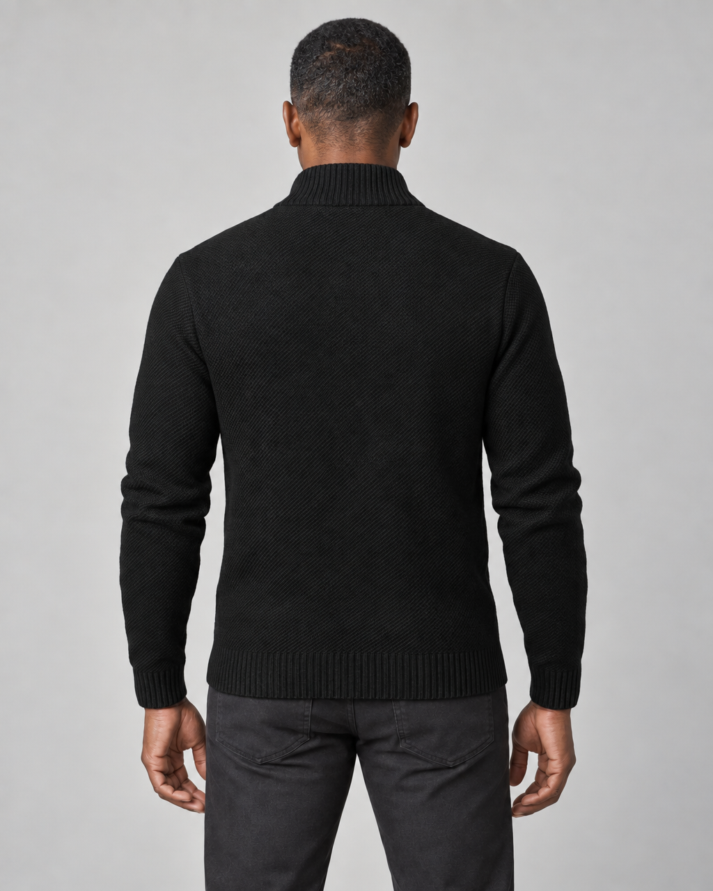 Back cropped view of a man wearing a black roll-neck jumper with ribbed collar, cuffs and hem