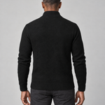 Back cropped view of a man wearing a black roll-neck jumper with ribbed collar, cuffs and hem