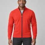 Cropped front view of a man wearing an orange zip-up sweater with a stand collar and black-trimmed pockets.