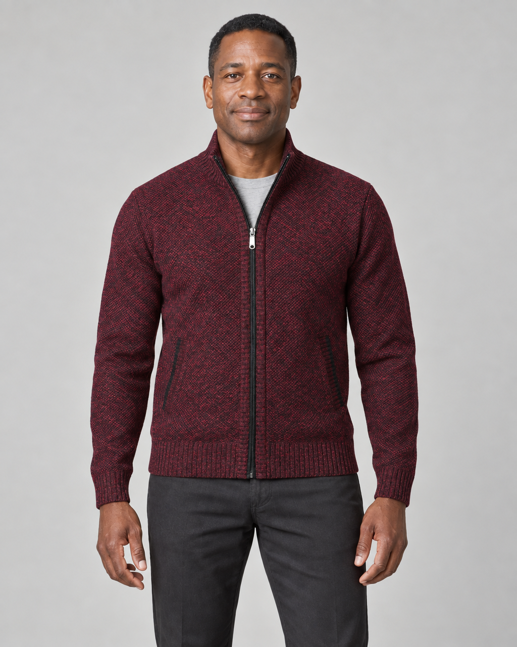 Front cropped view of a man wearing a wine red textured zip-up sweater with a stand collar