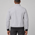 Back view of a light grey men's jacket with a raised collar and contrasting black cuffs and hem
