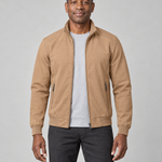 Front cropped view of a man wearing an open khaki jacket with a stand collar, ribbed cuffs and two zipped pockets.