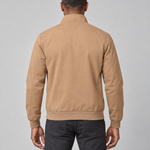 Back view of a man wearing a khaki jacket with a raised collar and ribbed cuffs and hem