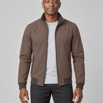 Front cropped view of a man wearing an open brown zip-up jacket with a raised collar and zipped side pockets