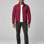 Full-body front view of a man wearing a burgundy zip-up jacket with black collar, cuffs and hem