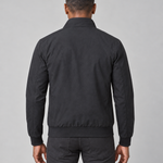 Back view of a man wearing a black jacket with a raised collar, ribbed cuffs and hem