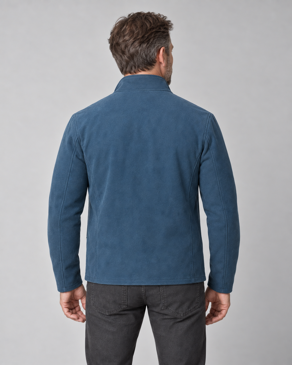 Concept image of a man from behind wearing a blue jacket with a stand collar and long sleeves