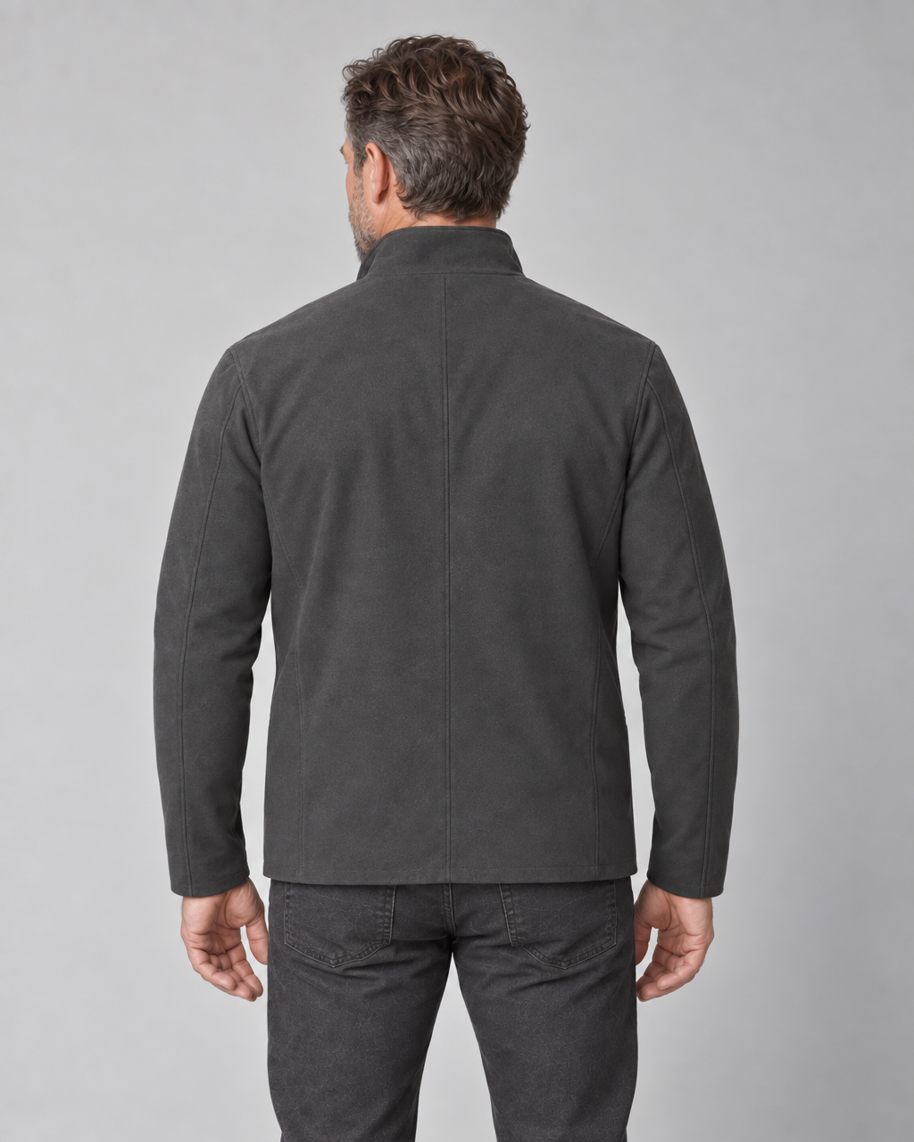 Cropped rear view of a man wearing a dark grey jacket with a stand collar and centre back seam.