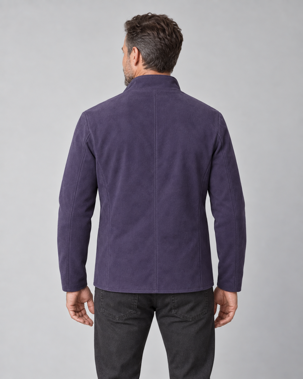 Cropped rear view of a man wearing a violet blazer with a raised collar and long sleeves.