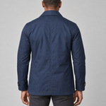 Back-view concept of a model wearing a navy blue short coat with a pointed collar and cuff tabs.