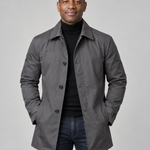 Front cropped view of a man wearing a grey button-front coat with a pointed collar and side pockets