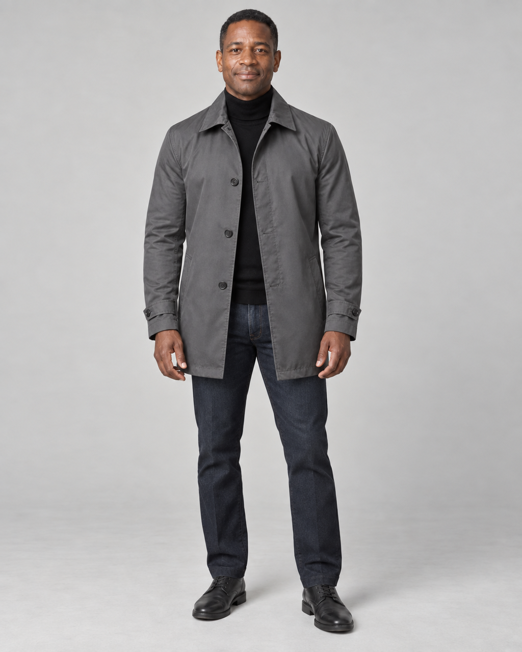 Full-body front view of a man wearing a grey button-front coat with a pointed collar and cuff tabs