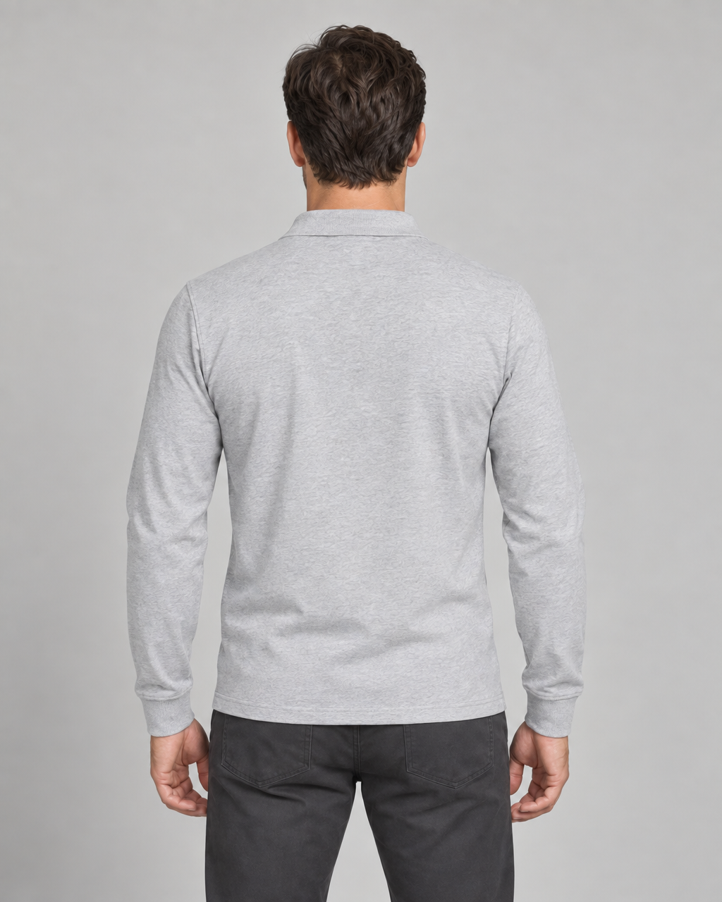 Back view of a man wearing a light grey long-sleeved collared shirt