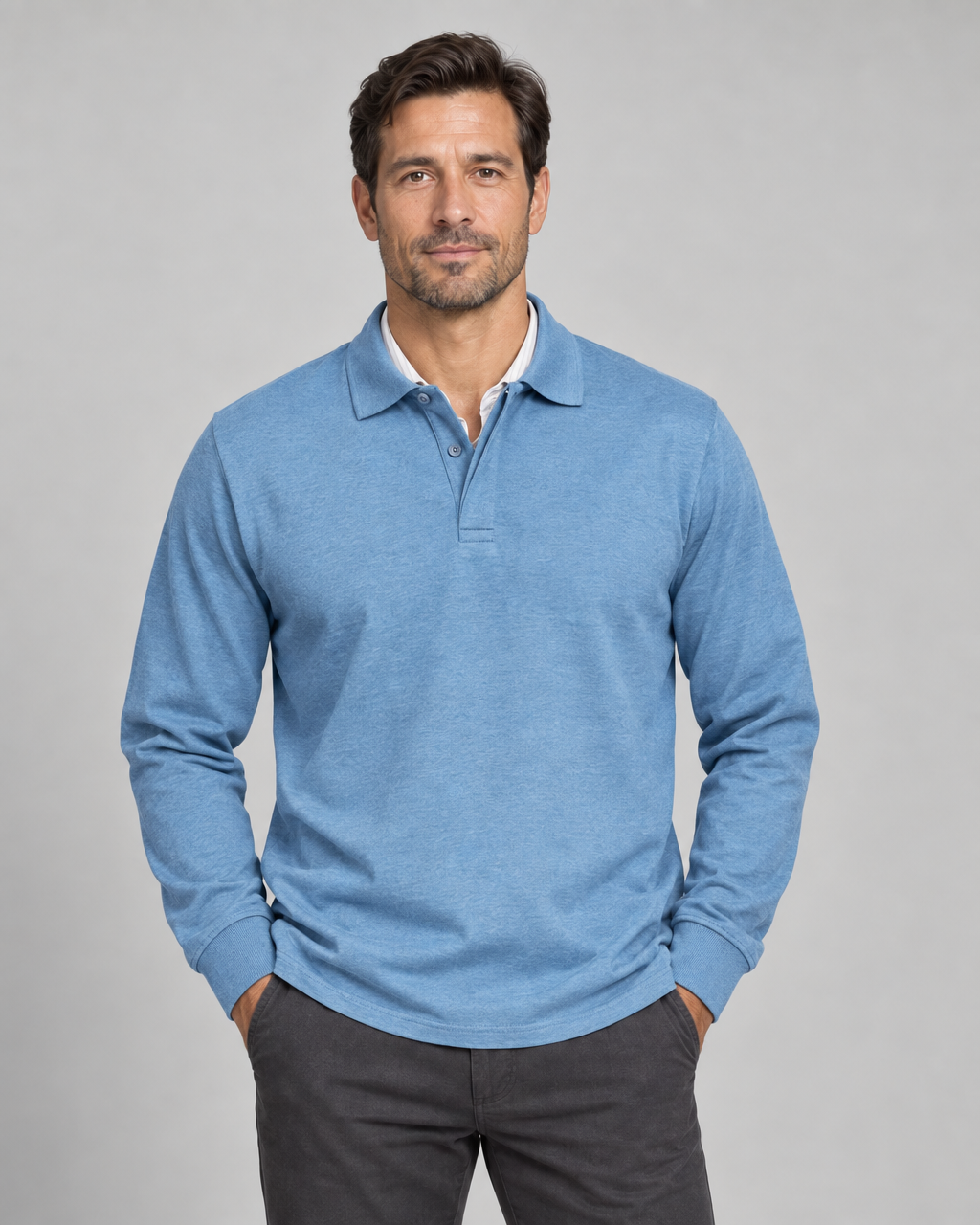 Front cropped view of a man wearing a light blue long-sleeved polo shirt with a buttoned collar