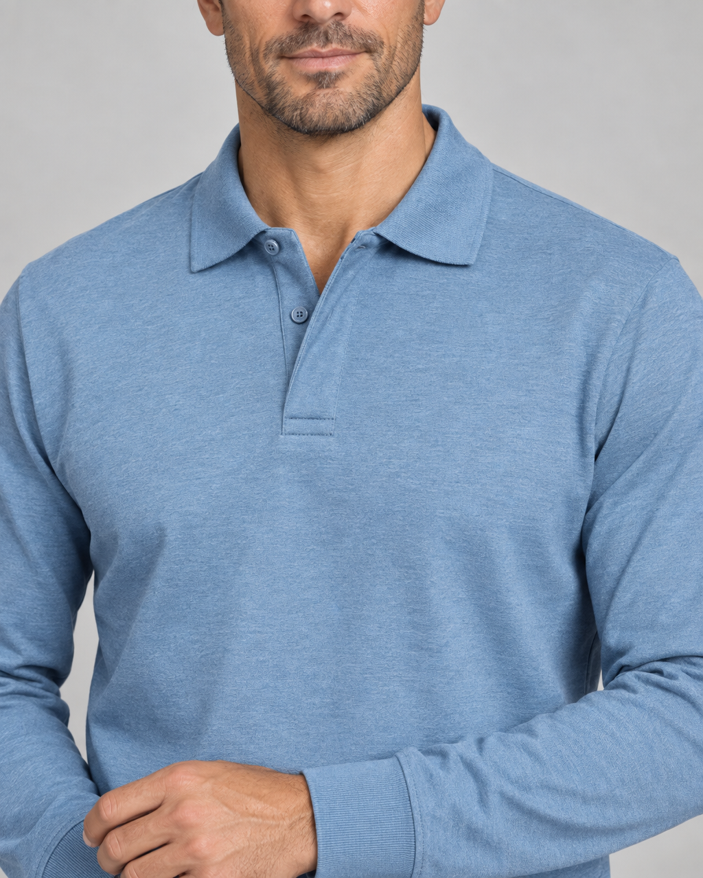 Close-up front view of a light blue long-sleeved polo shirt with a two-button placket and ribbed cuffs.