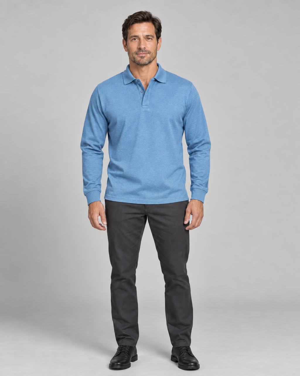 Full-length front view of a man wearing a light blue long-sleeve polo shirt