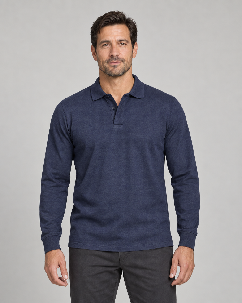 Front cropped view of a model wearing a navy long-sleeved polo shirt with a two-button placket.