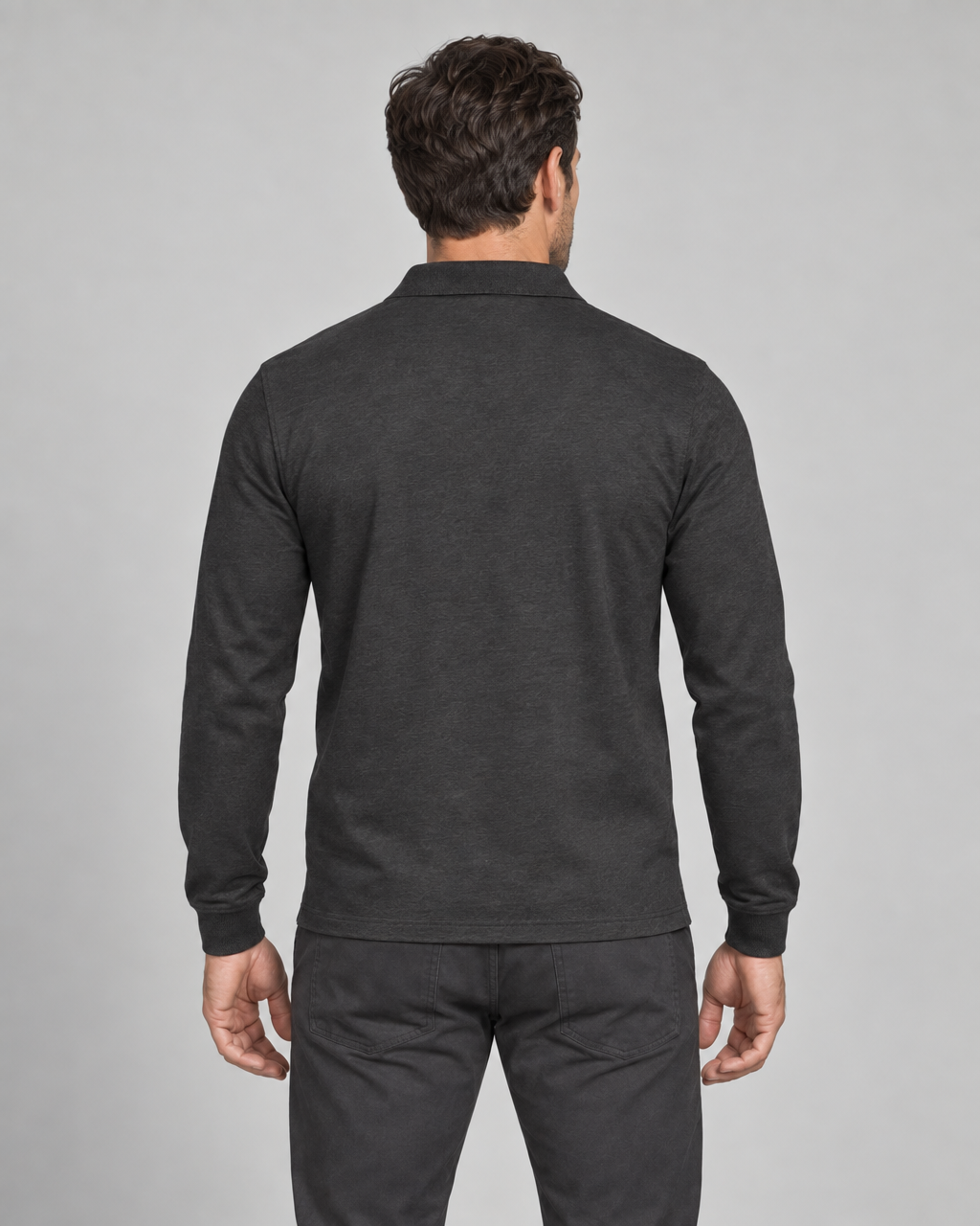 Back view of a model wearing a black long-sleeve collared shirt, shown from head to upper legs.