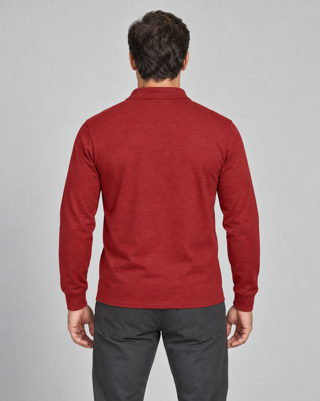 Back view of a man wearing a red long-sleeved collared shirt with ribbed cuffs