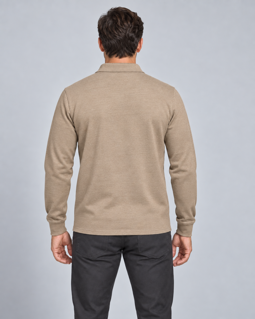 Back view of a model wearing a khaki long-sleeved collared shirt with a subtle tonal pattern