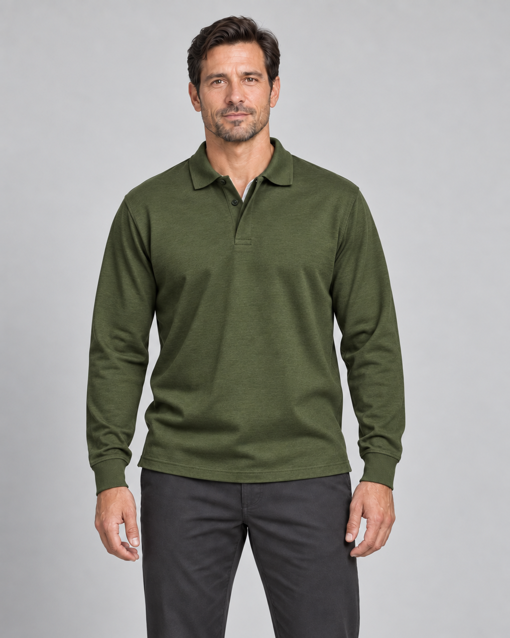 Front cropped view of a man wearing a military green long-sleeve polo shirt with a two-button placket